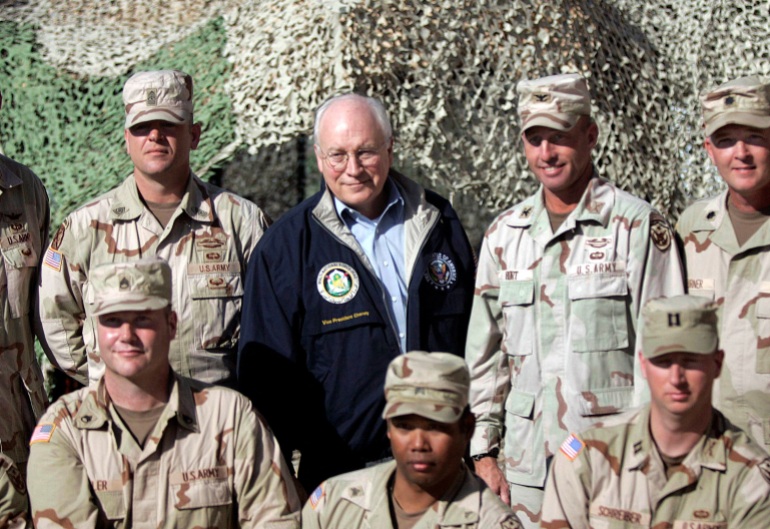 FILE PHOTO: U.S. Vice-President Dick Cheney poses with U.S. soldiers at the Taji Air Base in Iraq December 18, 2005. Cheney visited Iraq on Sunday for the first time since the 2003 invasion, as hardline leaders from both sides of the country's sectarian divide renewed calls for American troops to go home. Cheney, a chief architect of the war to oust Saddam Hussein, met Iraq's prime minister and president during his 8-hour visit, and hailed last Thursday's election as "tremendous". REUTERS/Lawrence Jackson/Pool)/File Photo