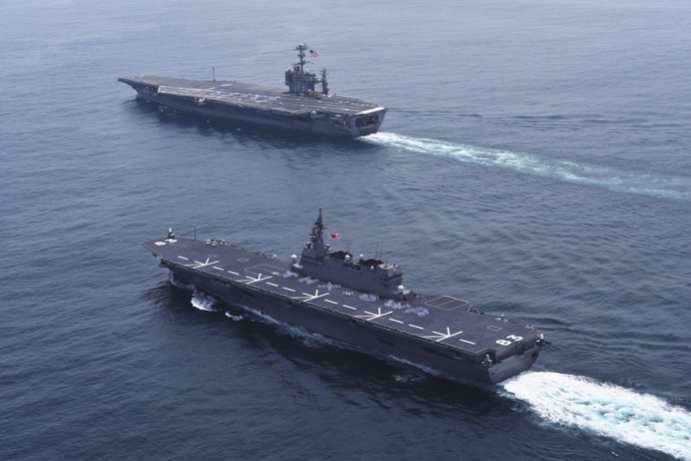 U.S. sailors form words on the decks of the USS George Washington aircraft carrier, as it leaves from the U.S. Navy's Yokosuka base, and Japan's biggest warship Izumo as it sails to send off USS George Washington, off Boso Peninsula, east of Tokyo