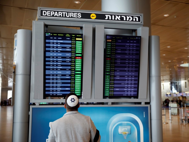 A man looks at a flight information board in the departures terminal after Israel said it will require anyone arriving from overseas to self-quarantine for 14 days as a precaution against the spread of coronavirus, at Ben Gurion International airport in Lod, near Tel Aviv, Israel March 10, 2020. REUTERS/Ronen Zvulun